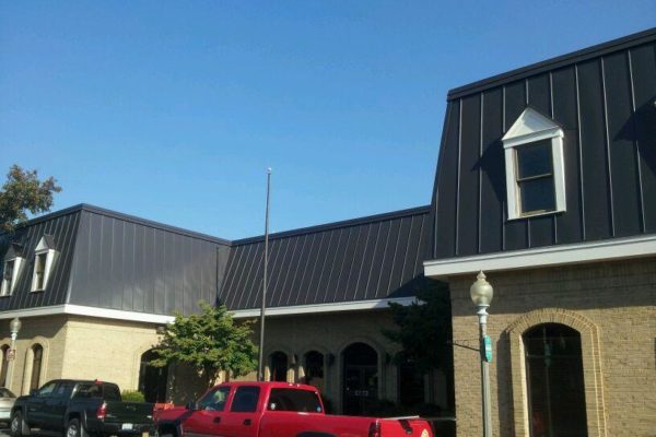 Brick building with dark metal roof