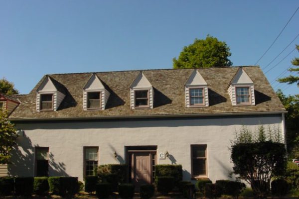 Stucco home with many dormers and coordinated roof